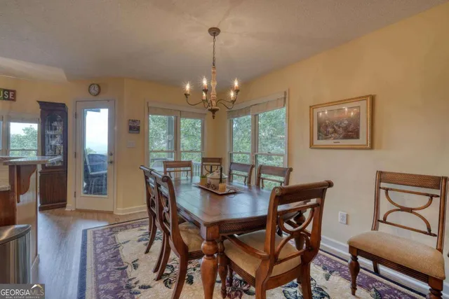 a bedroom with a bed and a large mirror on the dresser
