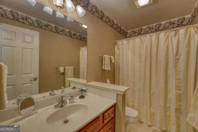 a bathroom with a sink mirror and a shower