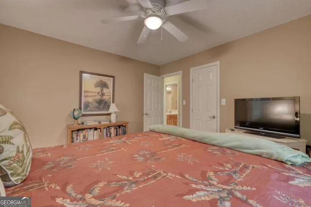 a bedroom with a bed and a flat screen tv