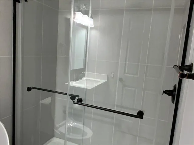 a bathroom with a shower and a sink