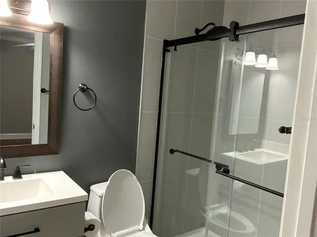 a bathroom with a sink toilet and shower