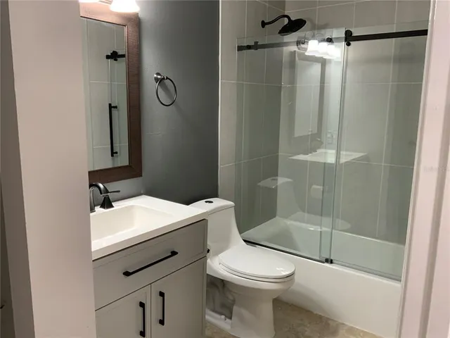 a bathroom with a sink mirror vanity and toilet