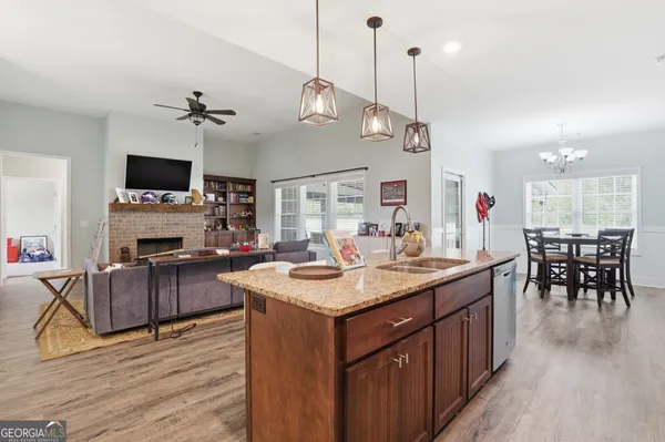 a kitchen with sink stove and wooden floor