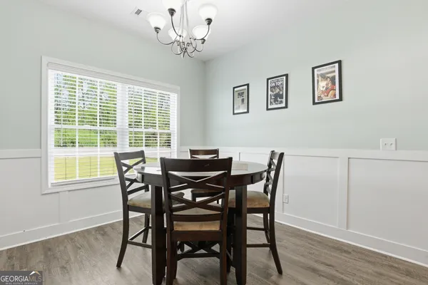 a view of a dining room with furniture window and wooden floor