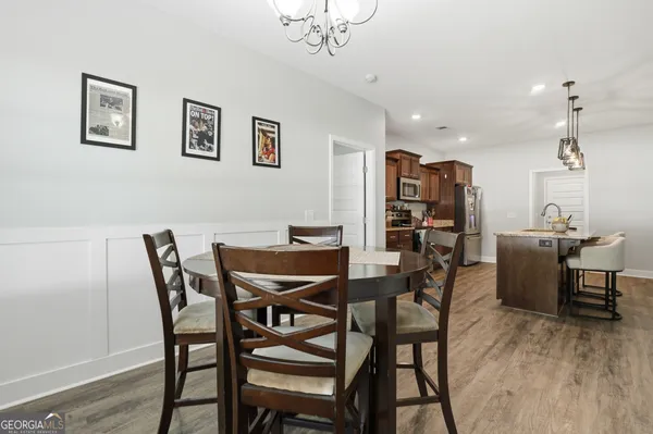 a view of a dining room with furniture and wooden floor