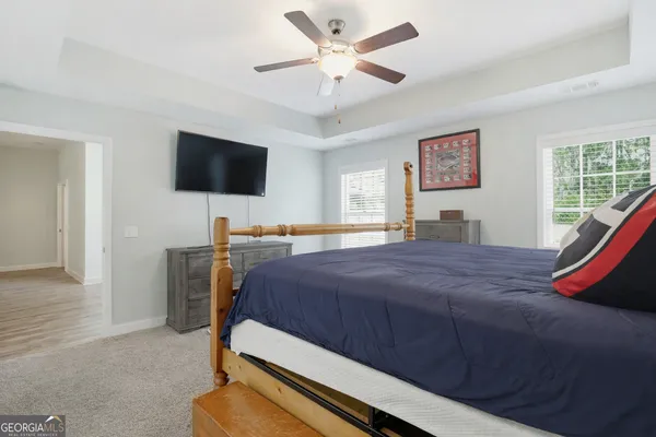 a bedroom with a bed and a flat screen tv