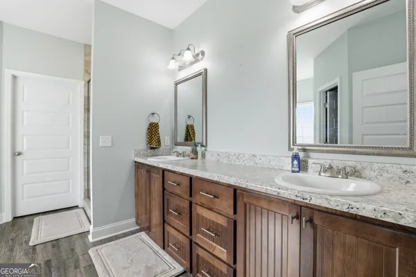 a bathroom with a granite countertop sink and a mirror