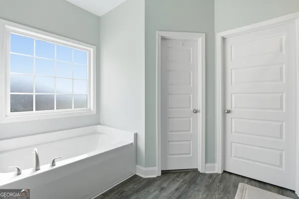 a bathroom with bathtub and window