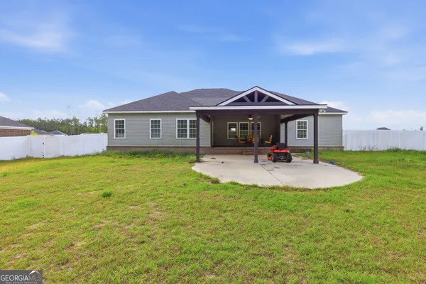 a front view of a house with a yard table and chairs