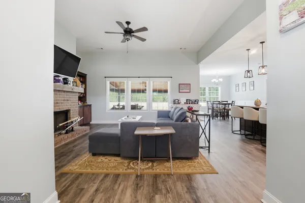 a living room with furniture a fireplace and a flat screen tv