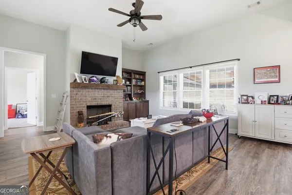 a living room with furniture fireplace and flat screen tv
