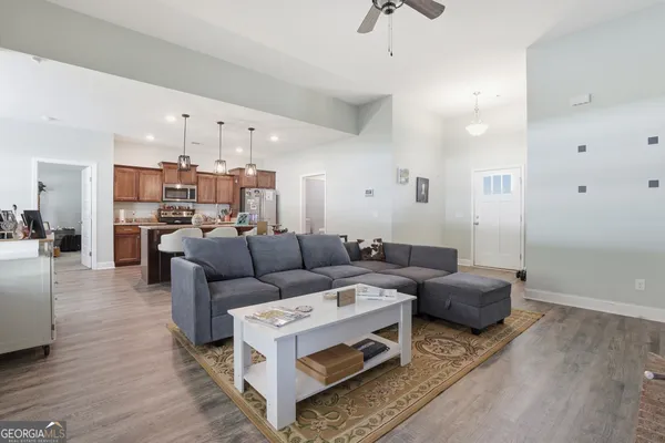 a living room with furniture and a chandelier