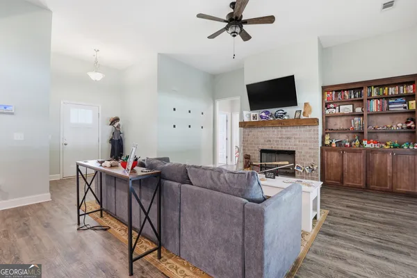 a living room with furniture a flat screen tv and a fireplace
