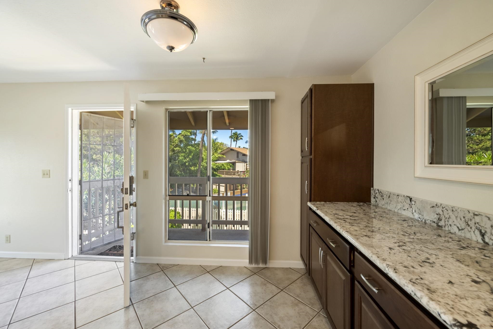 480 Kenolio Road, Unit 31205 Kihei, HI 96753 - Photo 14 of 45 a bathroom with a granite countertop sink and a window