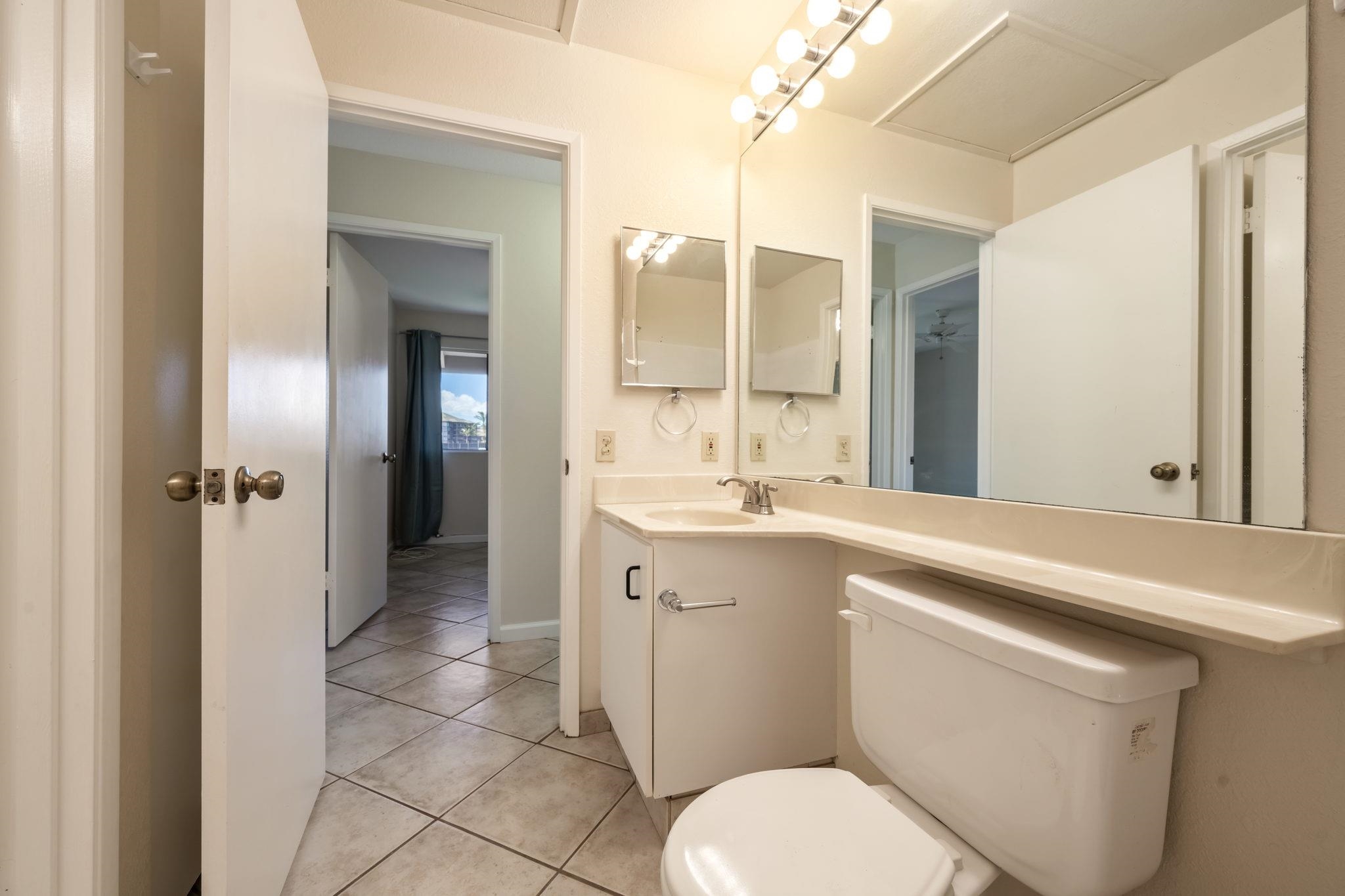 480 Kenolio Road, Unit 31205 Kihei, HI 96753 - Photo 26 of 45 a bathroom with a sink a toilet and shower
