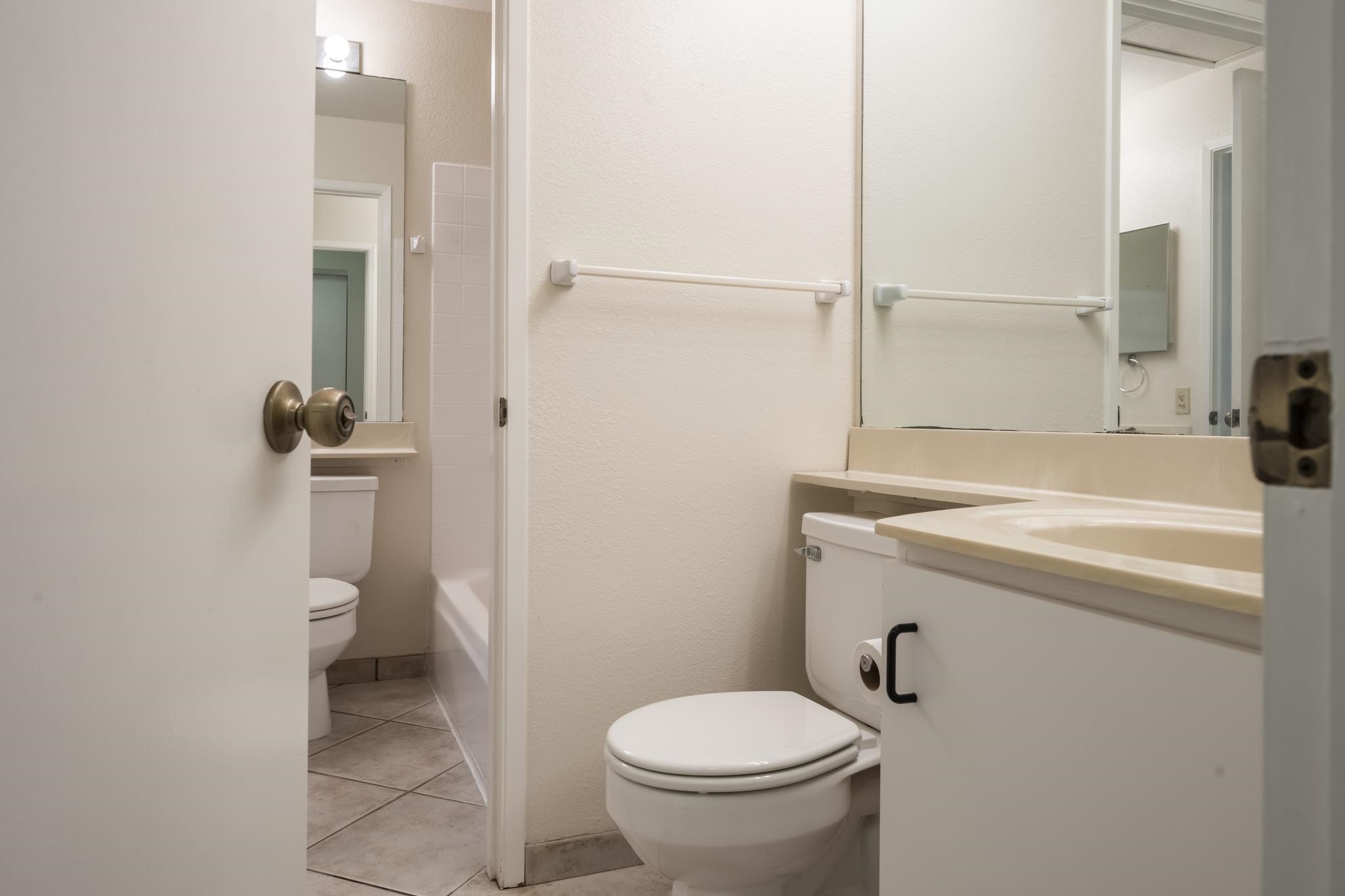 480 Kenolio Road, Unit 31205 Kihei, HI 96753 - Photo 33 of 45 a bathroom with a sink a toilet and a mirror