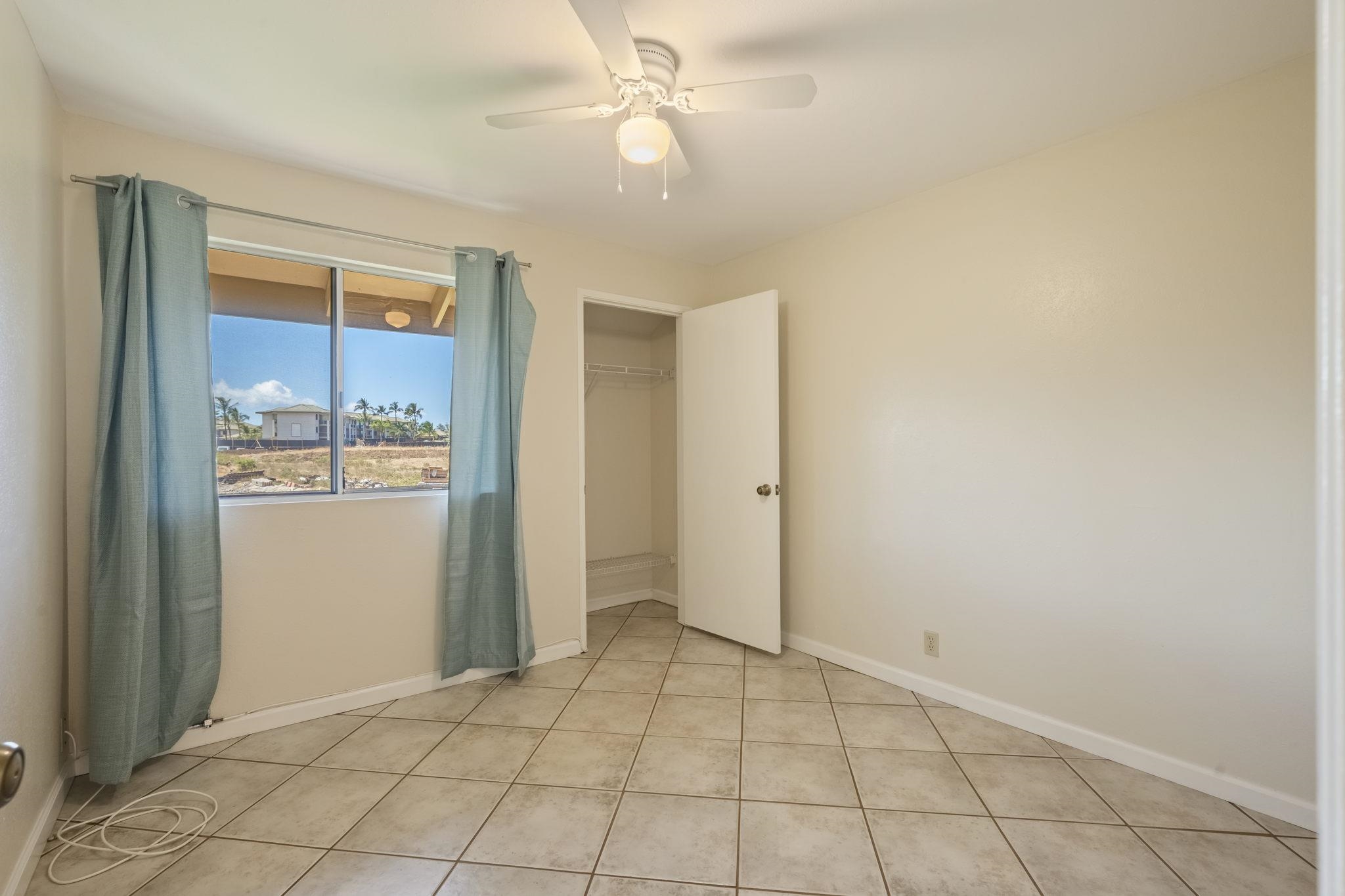 480 Kenolio Road, Unit 31205 Kihei, HI 96753 - Photo 36 of 45 a view of an empty room and window with chandelier fan