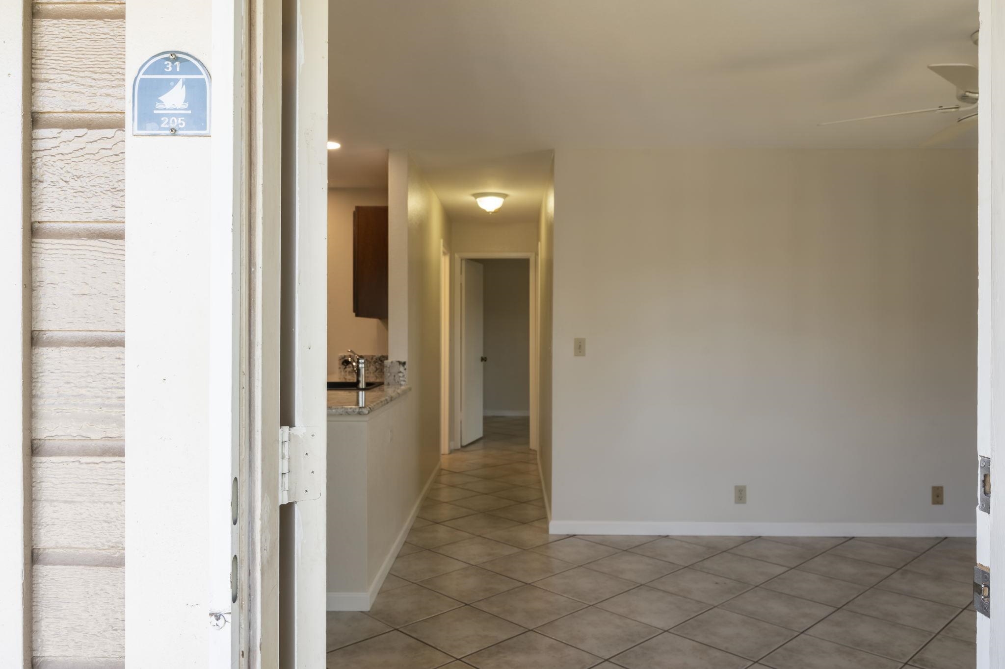 480 Kenolio Road, Unit 31205 Kihei, HI 96753 - Photo 8 of 45 a view of a hallway with wooden floor