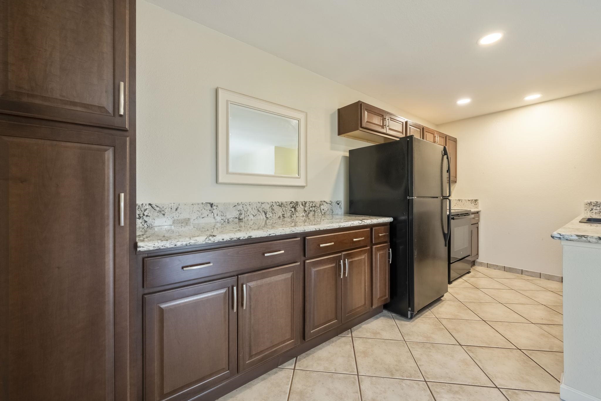 480 Kenolio Road, Unit 31205 Kihei, HI 96753 - Photo 10 of 45 a kitchen with stainless steel appliances granite countertop a refrigerator and a sink