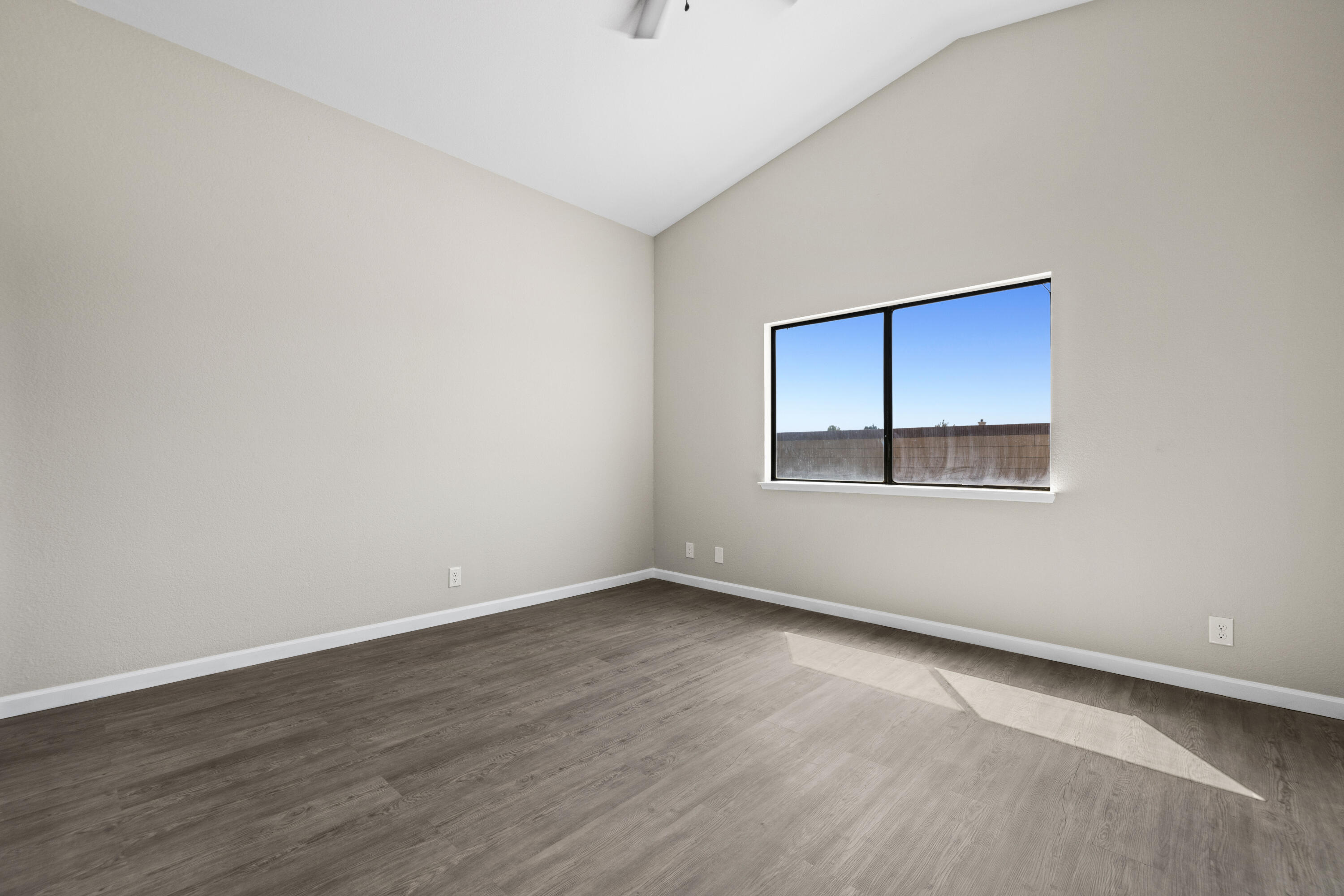 1270 Ave H4 Lancaster, CA 93534 - Photo 19 of 39 a view of an empty room with wooden floor and a window