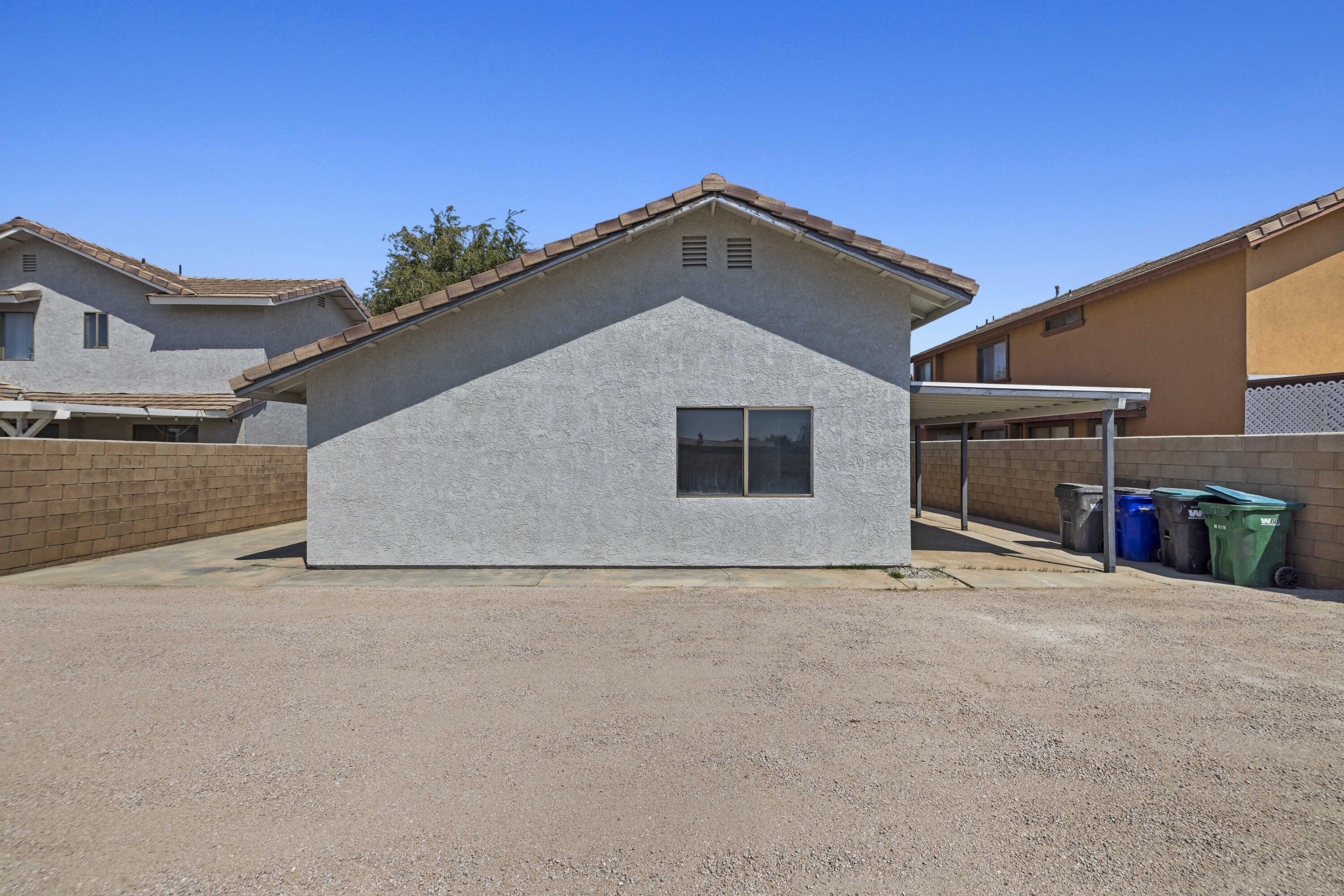 1270 Ave H4 Lancaster, CA 93534 - Photo 27 of 39 a view of an house with backyard and a garage