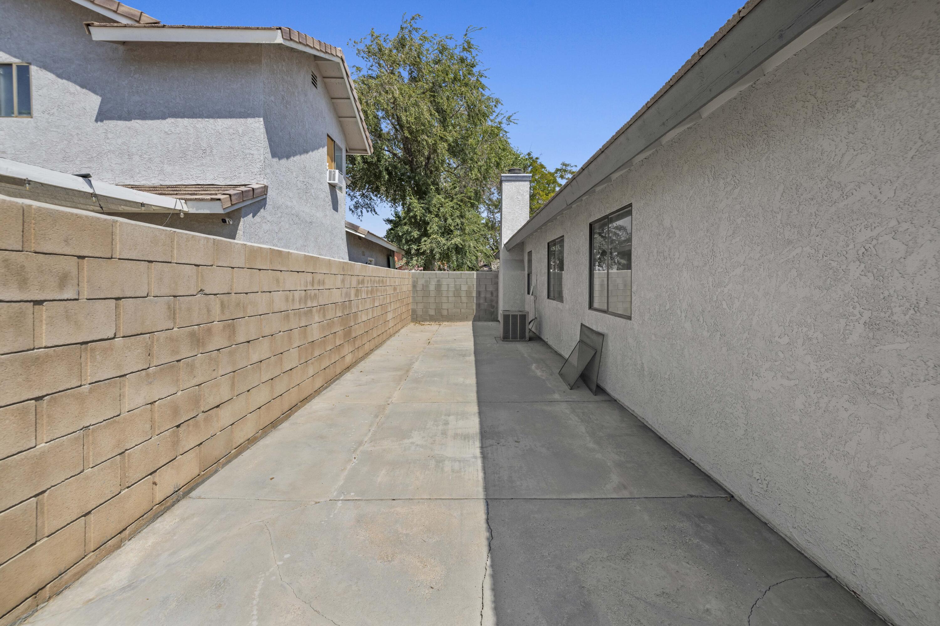 1270 Ave H4 Lancaster, CA 93534 - Photo 29 of 39 a pathway of a house with a yard