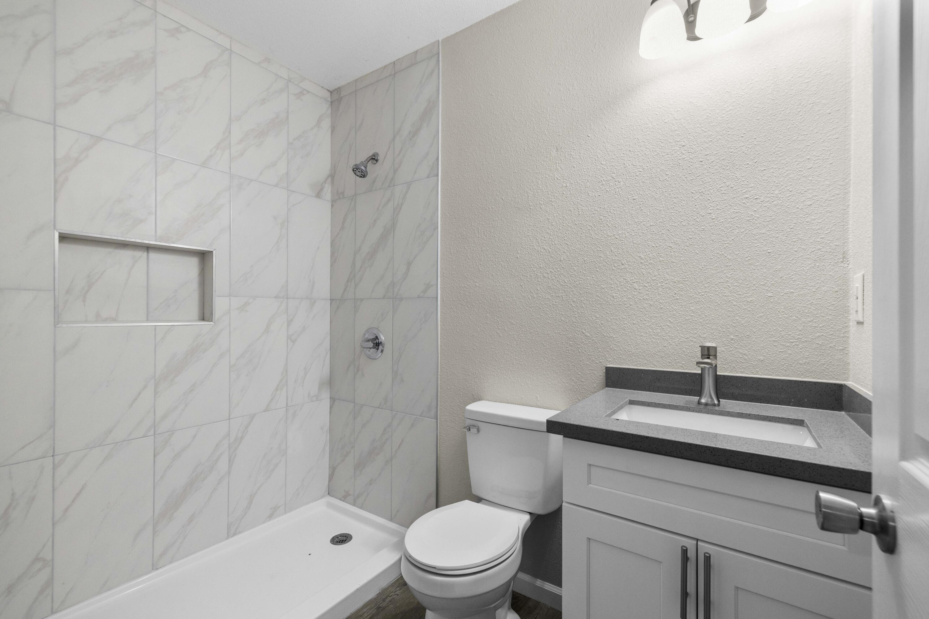 1270 Ave H4 Lancaster, CA 93534 - Photo 37 of 39 a bathroom with a sink a toilet and shower