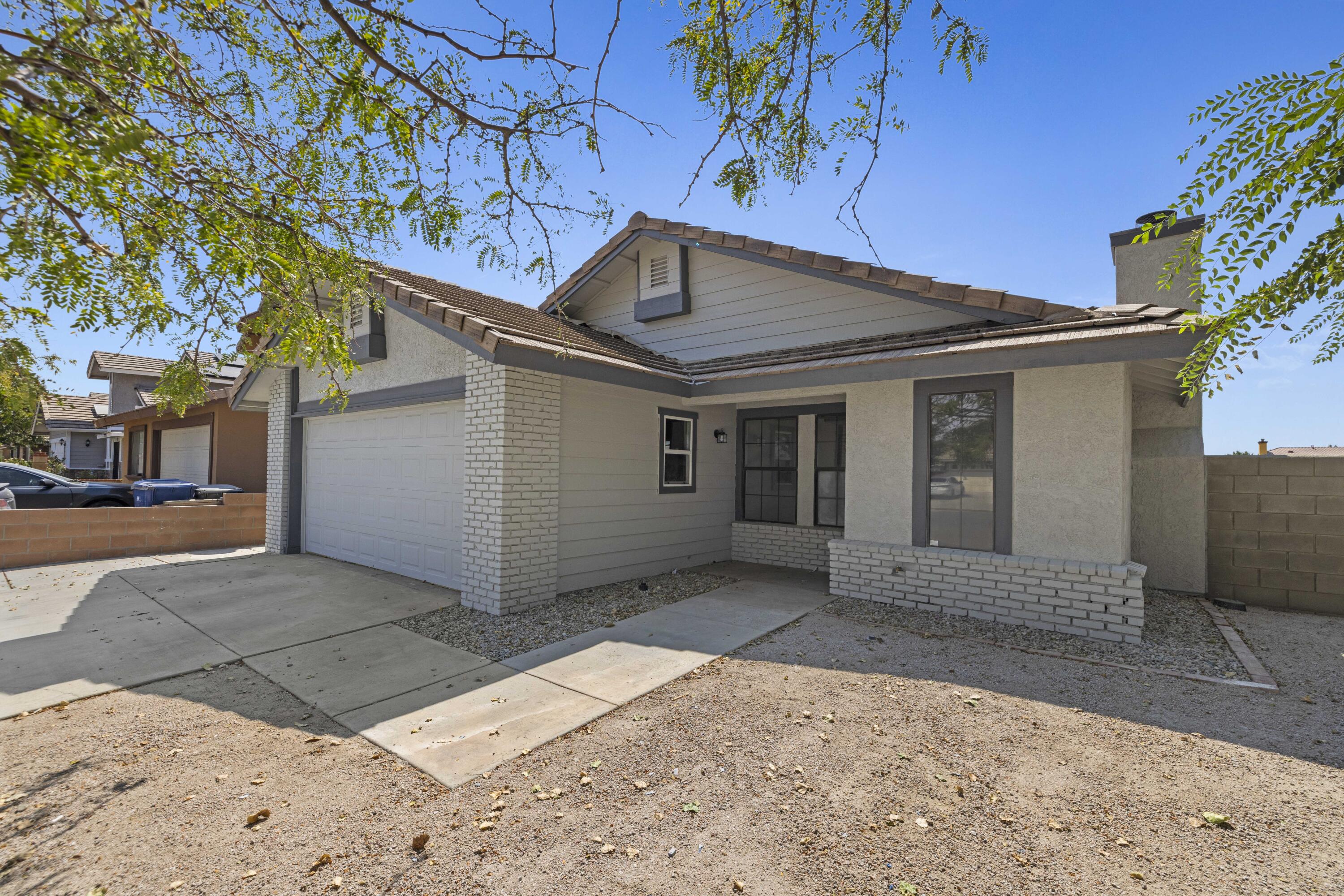 1270 Ave H4 Lancaster, CA 93534 - Photo 38 of 39 a house with a tree in front of it