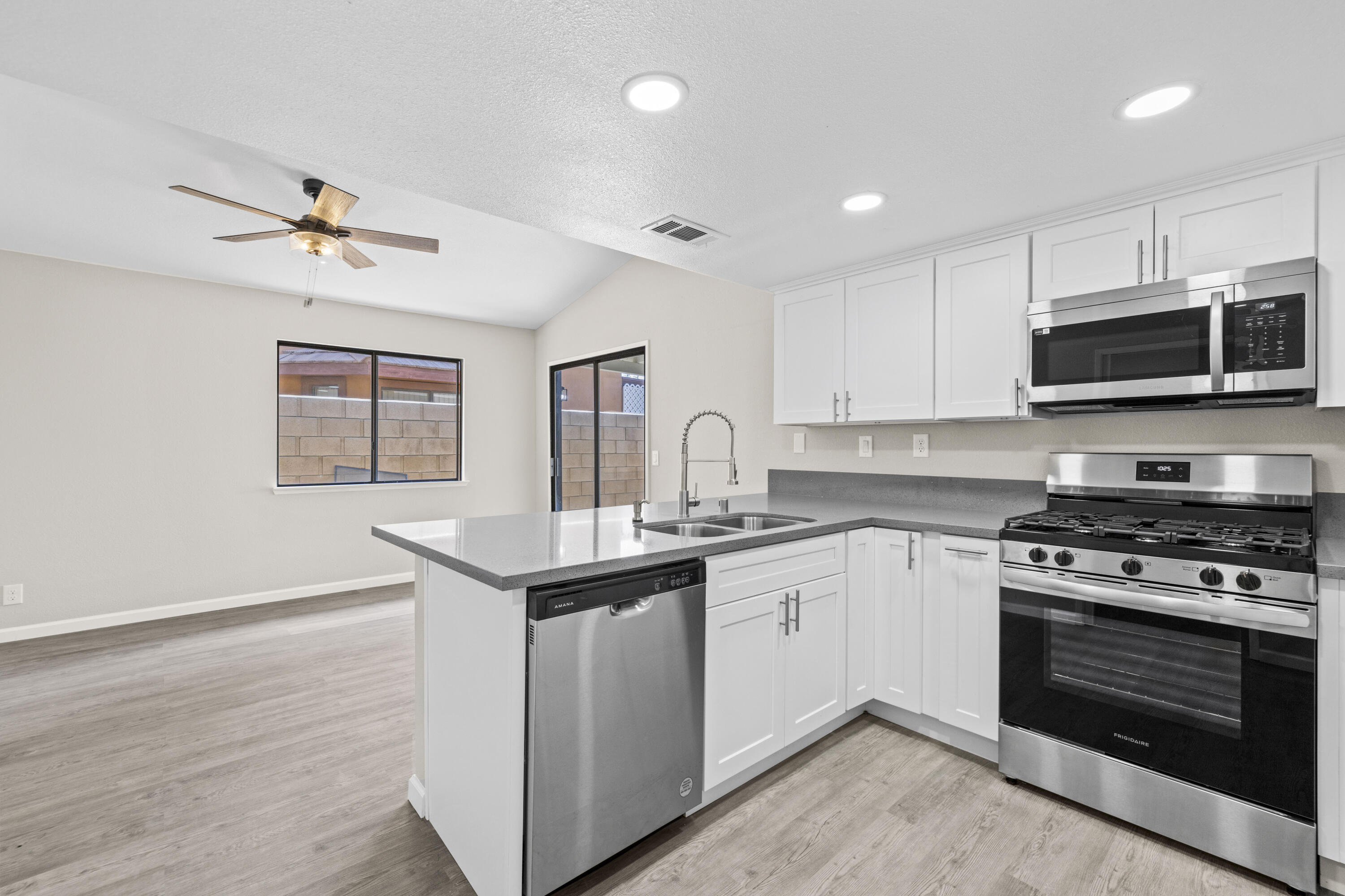 1270 Ave H4 Lancaster, CA 93534 - Photo 6 of 39 a kitchen with stainless steel appliances granite countertop a stove a sink and a microwave