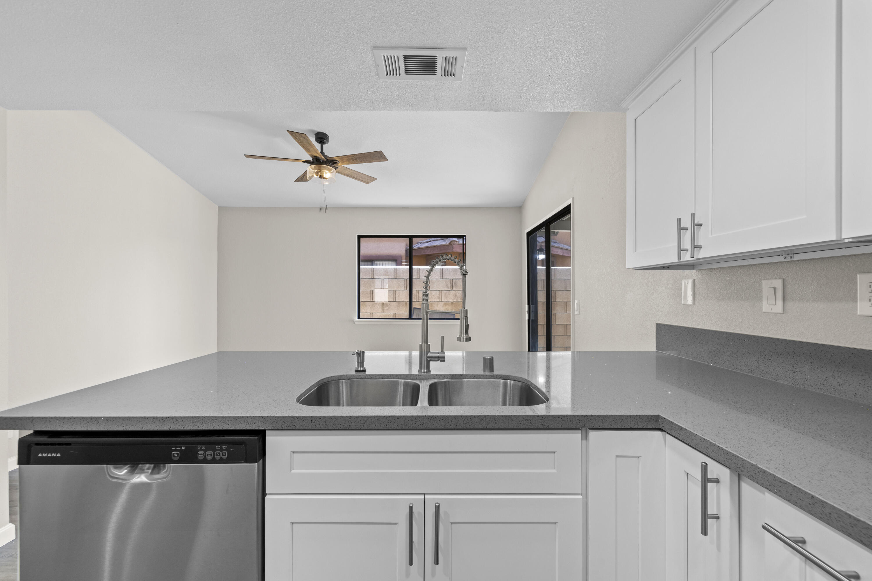 1270 Ave H4 Lancaster, CA 93534 - Photo 7 of 39 a kitchen with stainless steel appliances a sink dishwasher a refrigerator and white cabinets