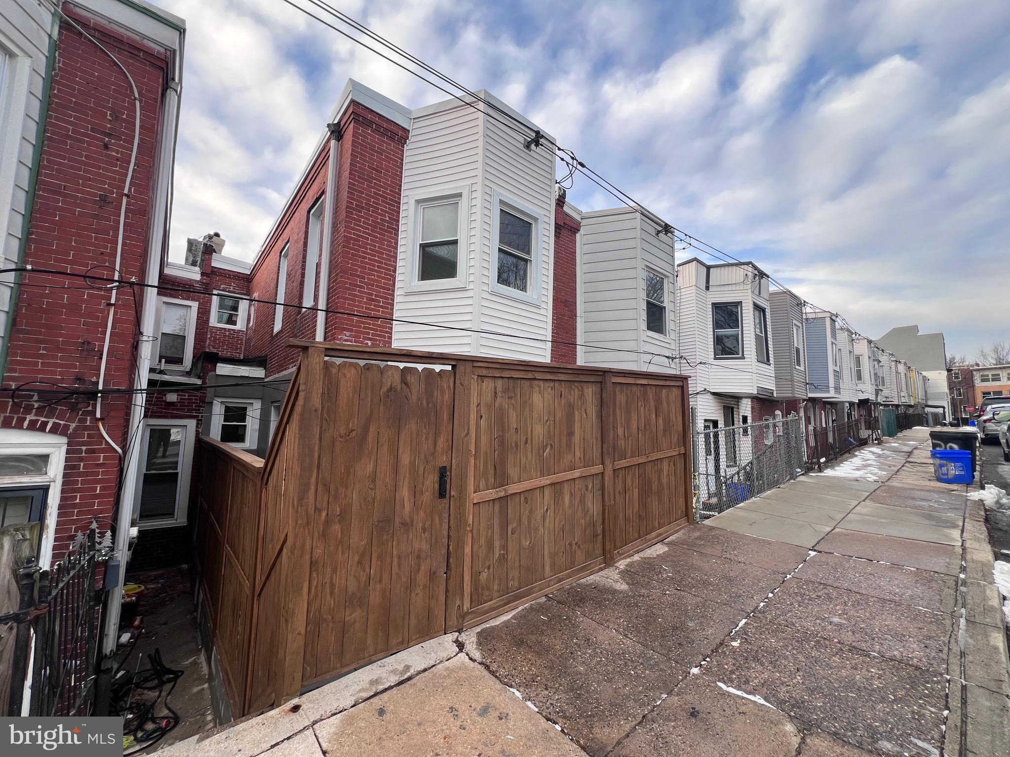 40 West Sharpnack Street Philadelphia, PA 19119 - Photo 13 of 18 a view of a house with a wooden fence