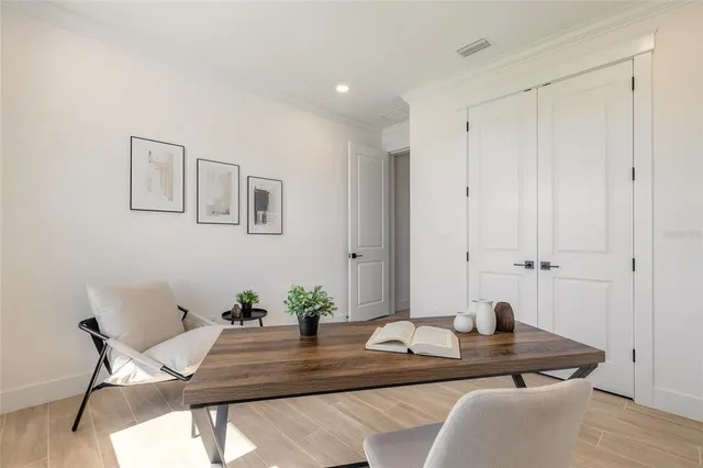 a dining room with furniture and wooden floor