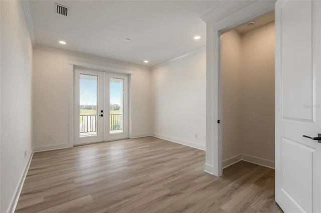 a view of wooden floor and windows in an empty room