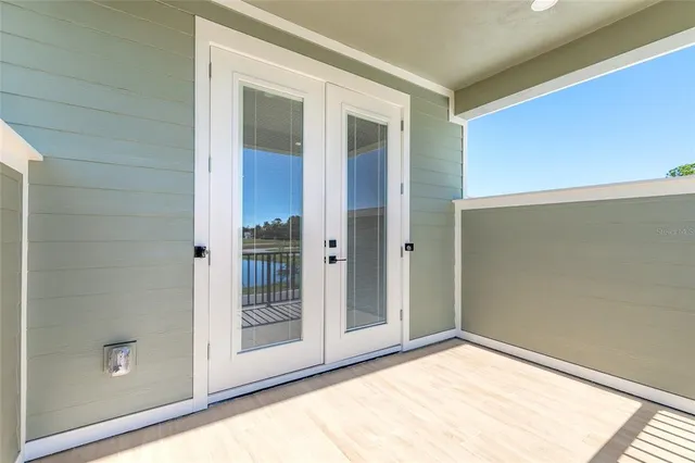 a view of an empty room with glass door