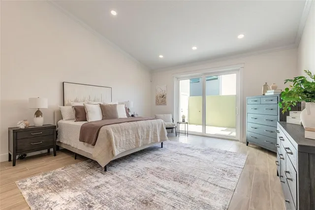 a spacious bedroom with a bed and a cabinets