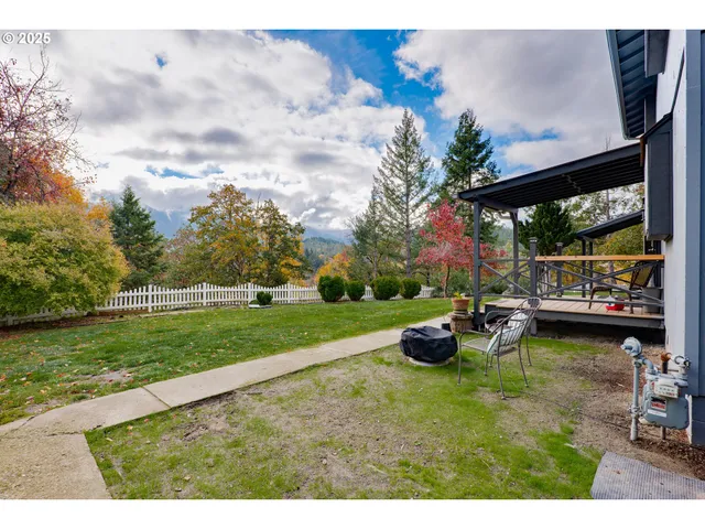a view of a house with wooden fence