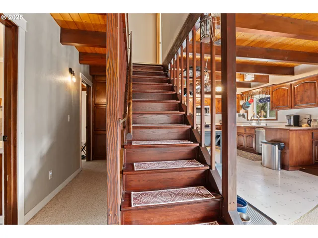 a living room with furniture a window and a flat screen tv