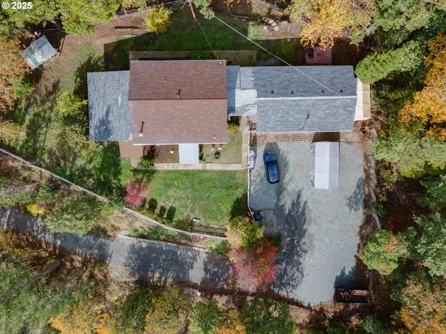 an aerial view of a house with table and chairs