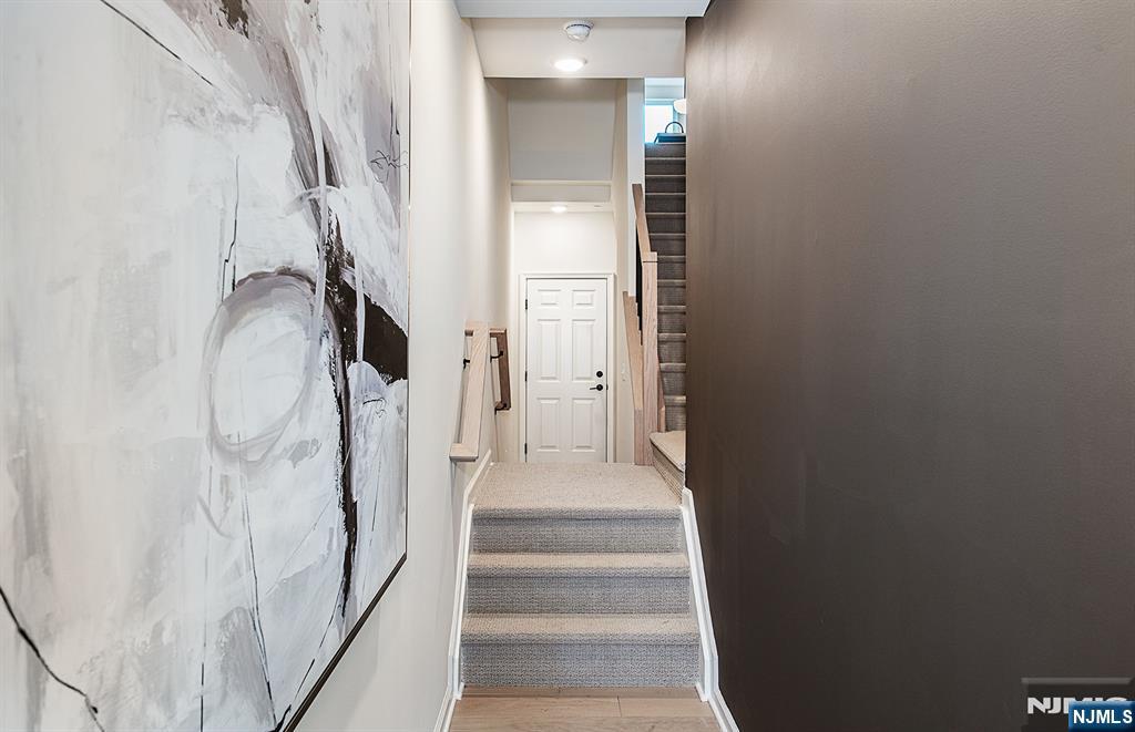 400 Sycamore Street, Unit 405 Kearny, NJ 07032 - Photo 13 of 28 a view of a hallway with a white walls and stairs