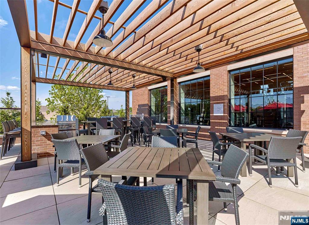 400 Sycamore Street, Unit 405 Kearny, NJ 07032 - Photo 26 of 28 a outdoor space with lots of tables a large window and chairs