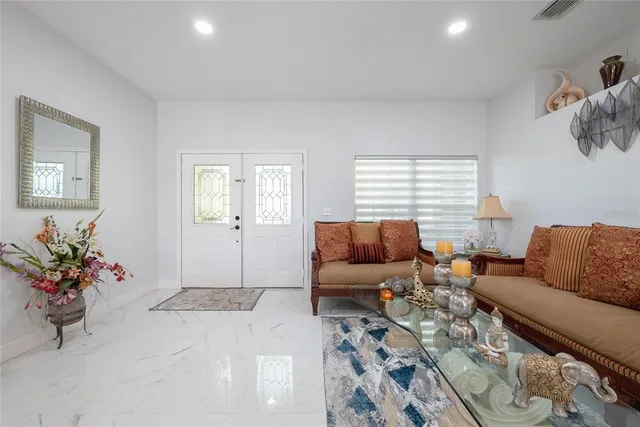 a living room with furniture flowerpot and window