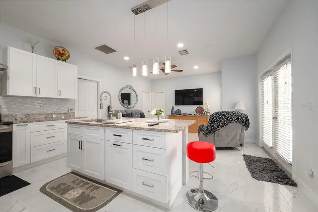 a kitchen with a sink cabinets and window