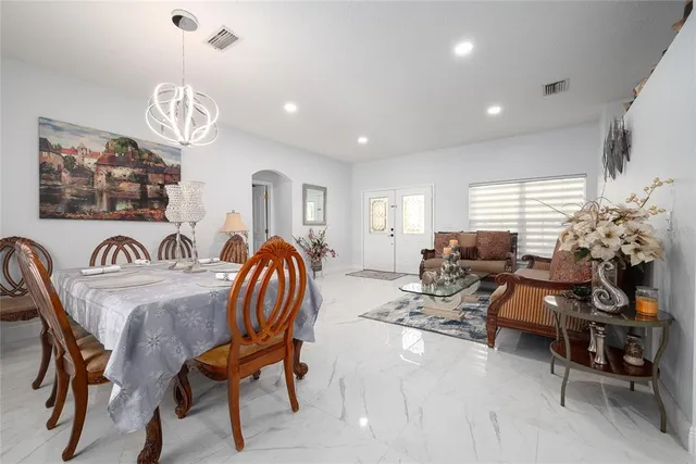 a living room with furniture a window and a chandelier