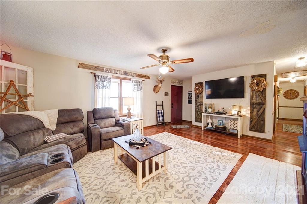 411 Gulledge Parker Road Monroe, NC 28112 - Photo 2 of 29 a living room with furniture and a flat screen tv