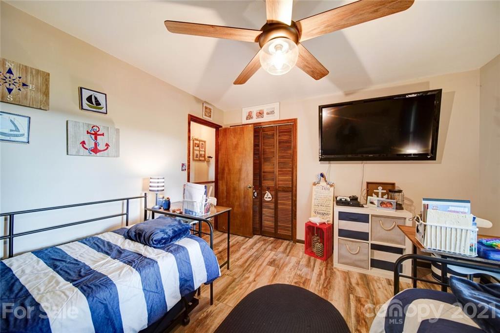 411 Gulledge Parker Road Monroe, NC 28112 - Photo 11 of 29 a bedroom with a bed and a flat screen tv