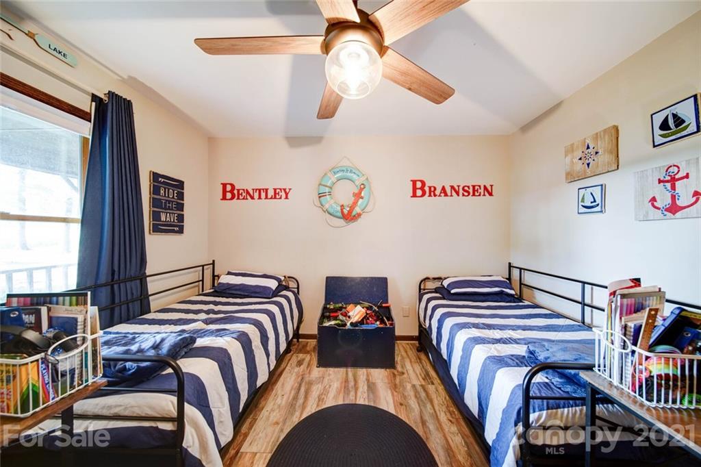 411 Gulledge Parker Road Monroe, NC 28112 - Photo 12 of 29 a bedroom with two beds and a book shelf