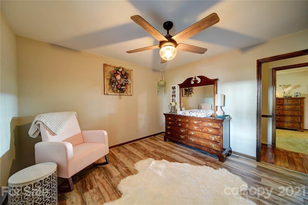 411 Gulledge Parker Road Monroe, NC 28112 - Photo 13 of 29 a bedroom with a bed and wooden floor