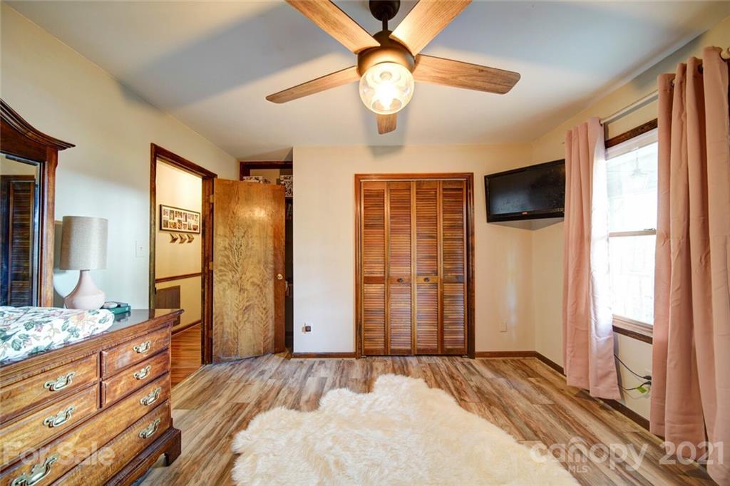 411 Gulledge Parker Road Monroe, NC 28112 - Photo 14 of 29 a bedroom with a bed and a large mirror on the dresser