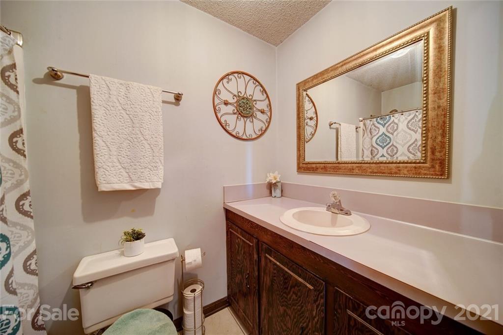 411 Gulledge Parker Road Monroe, NC 28112 - Photo 15 of 29 a bathroom with a toilet a sink and a mirror
