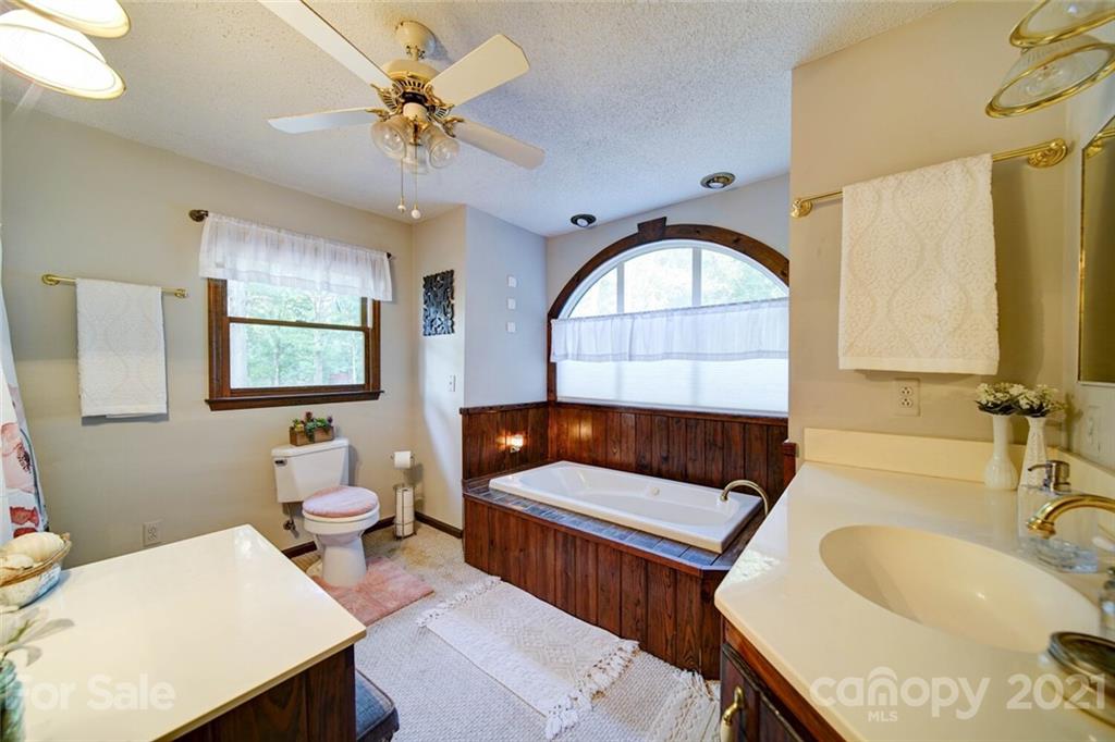 411 Gulledge Parker Road Monroe, NC 28112 - Photo 19 of 29 a living room with a couch and a chandelier